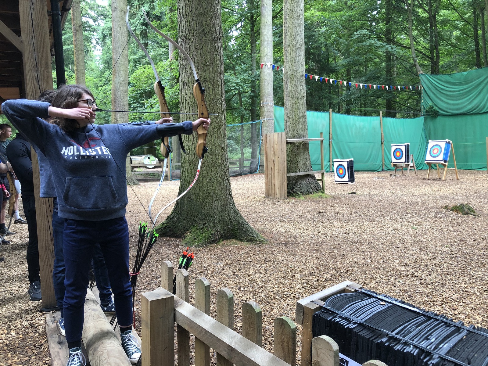 Female archer shooting on outdoor range